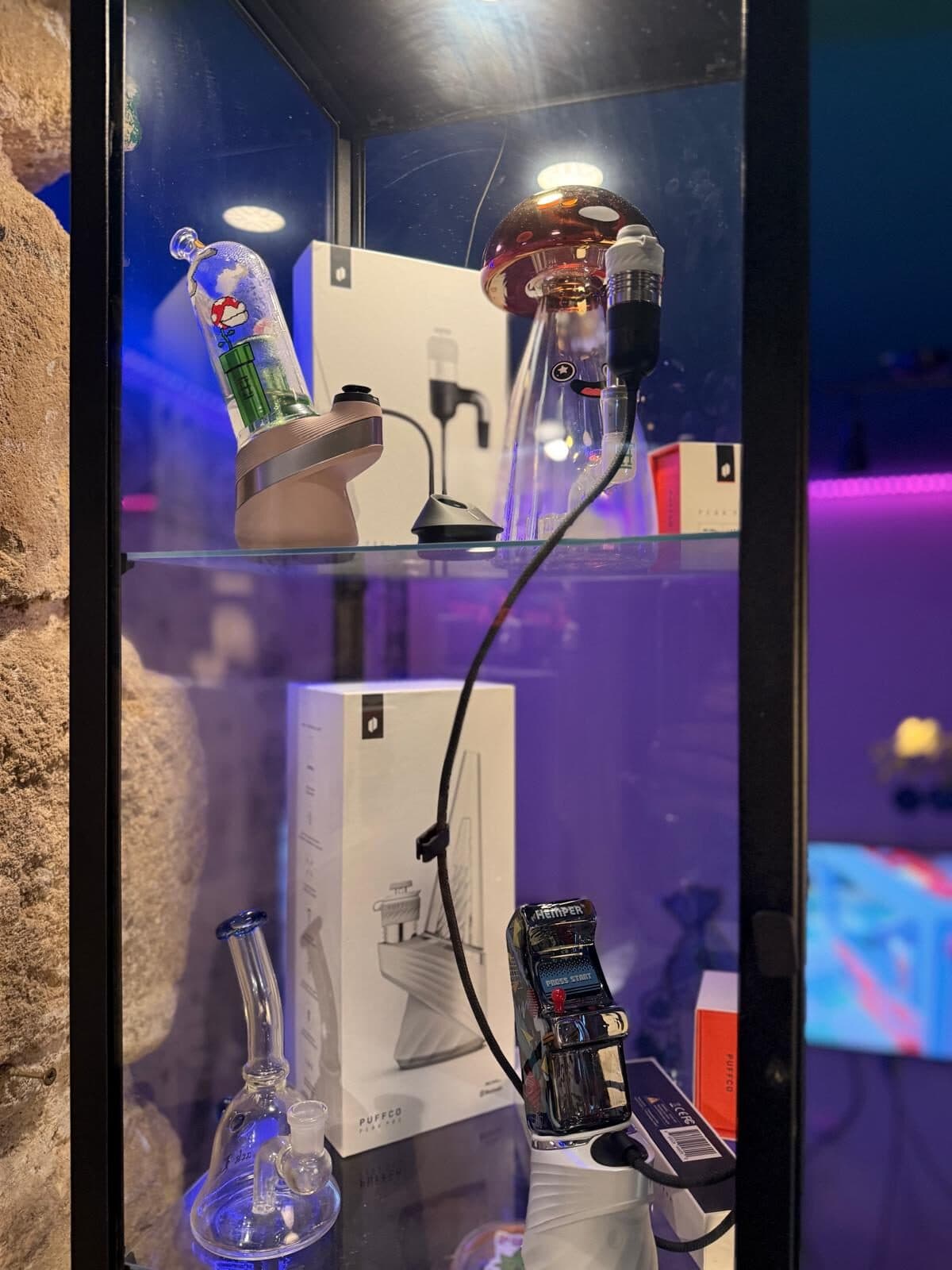 Glass pieces lit by neon inside the club display case