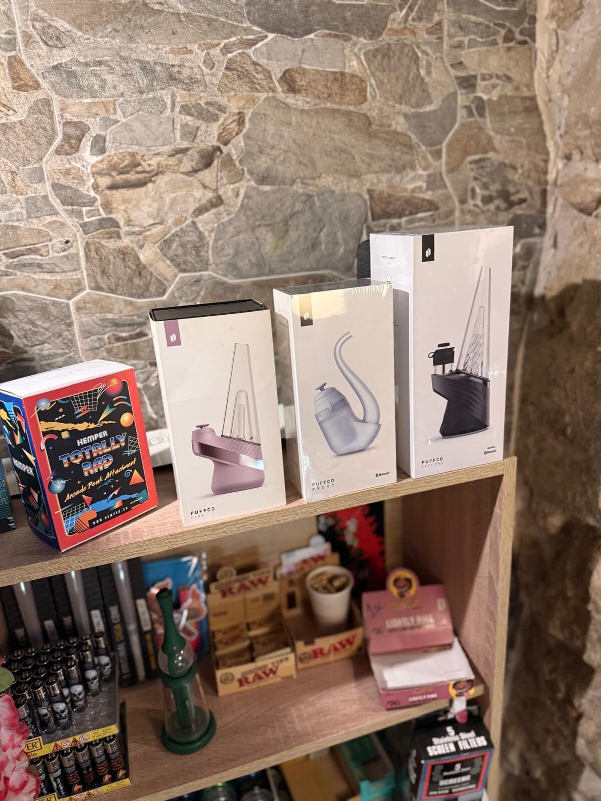Boxed vaporisers arranged on the stone wall shelf